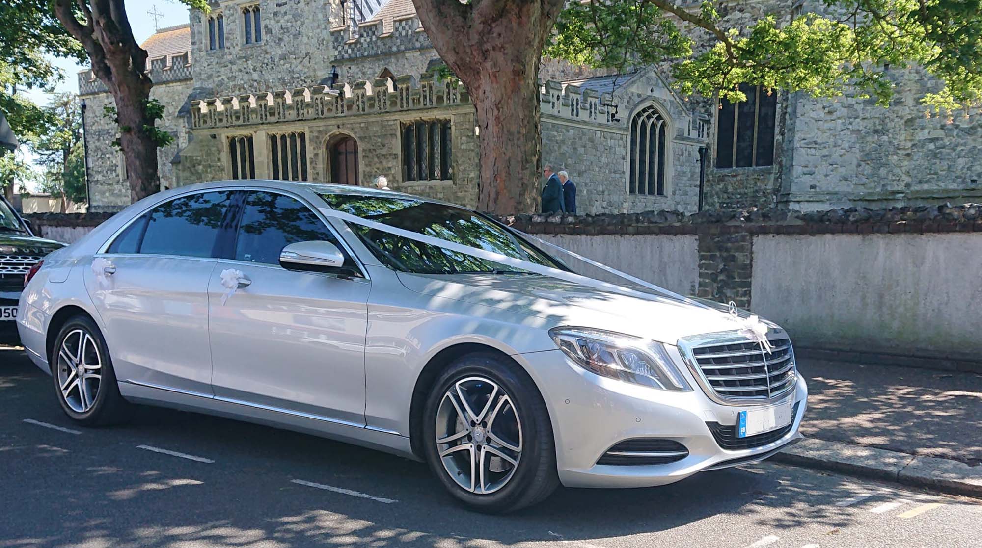 Sliver Mercedes S class parked at church